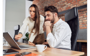 Management team reviewing items on a computer.