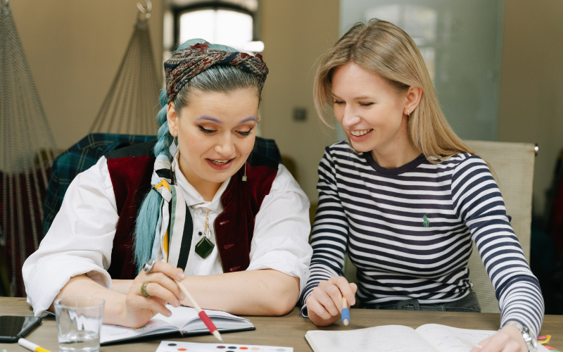 Manager and team member reviewing CliftonStrengths report